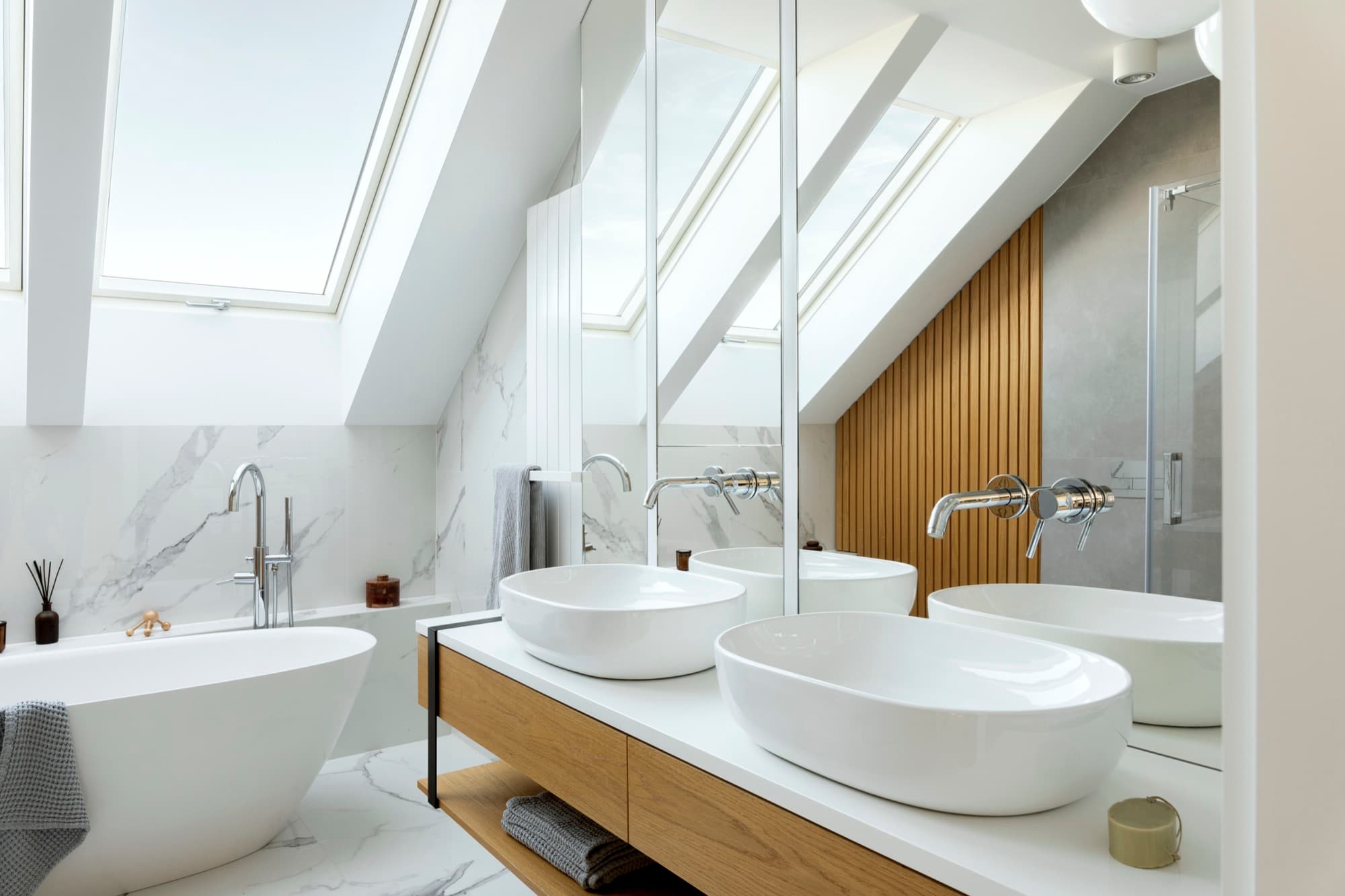 Bright bathroom with skylights above a double sink vanity