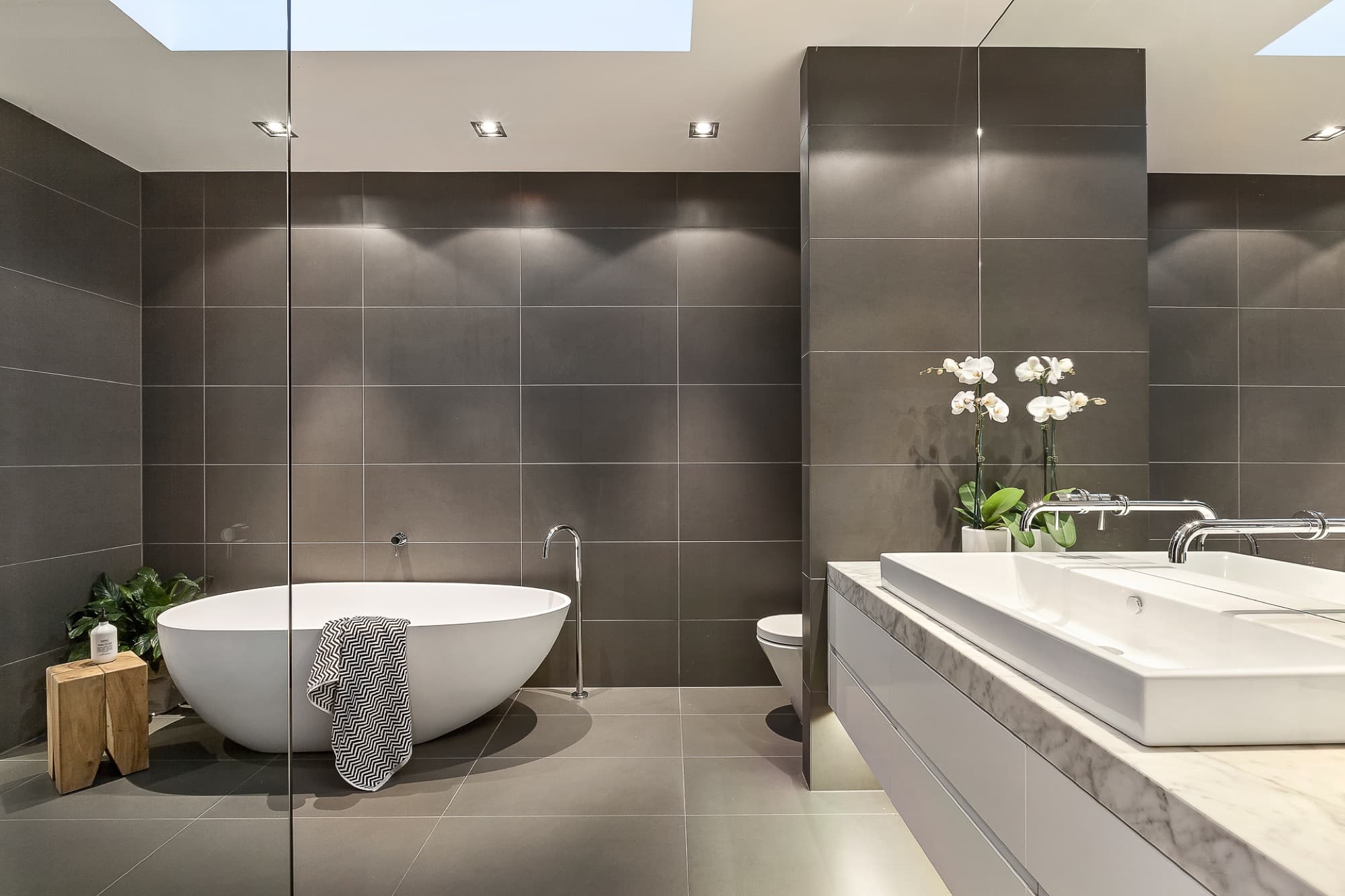 Modern bathroom with white sanitaryware and glazed shower screen